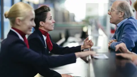 Getty Images Senior Man checking in at the airport