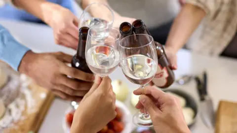 Getty Images Drinks glasses held up in a cheers