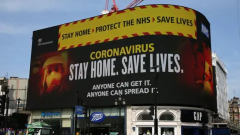 Getty Images A huge sign displays health advice at Piccadilly Circus in London in April 2020