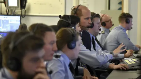 PA Media Prince William wearing a headset