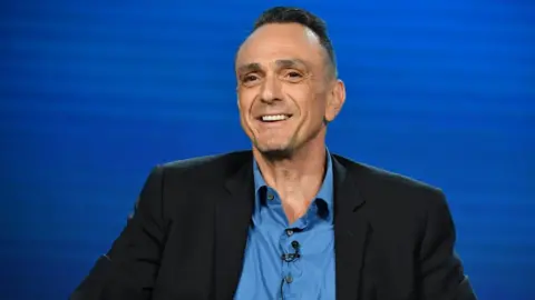 Getty Images Hank Azaria speaks to the media in California on 16 January 2020.