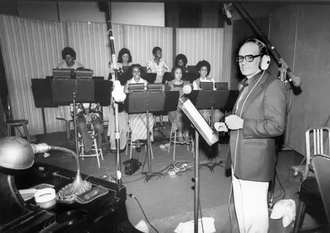 Getty Images Morricone with singers in a recording studio