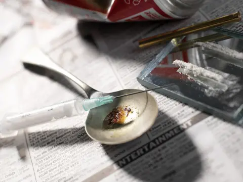 Science Photo Library Needle and drugs