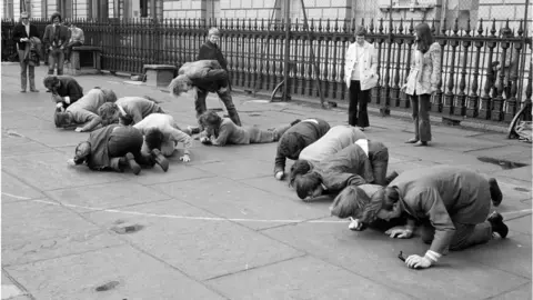 Getty Images People pushing peas