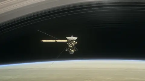 NASA/JPL-Caltech Artwork: Cassini is running the narrow gap between the top of the planet's atmosphere and the rings