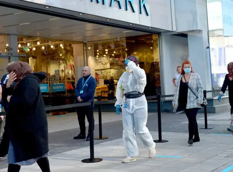 PA Media Shoppers queue to enter a Primark store