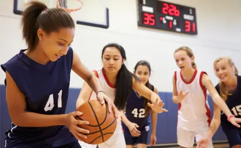 Getty Images Teenagers playing basketball