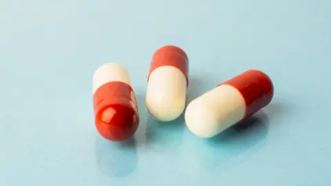 Getty Images Red and white pills