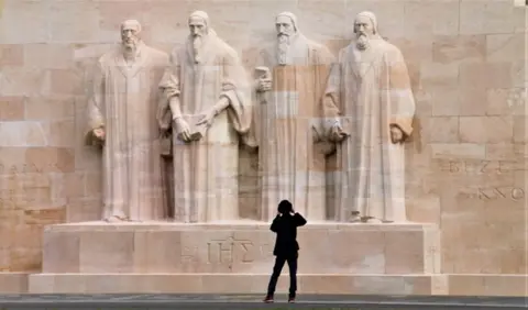 Stuart Else Person standing by a statue in Geneva