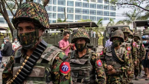 Getty Images Soldiers are seen patrolling the streets in Thingangyun