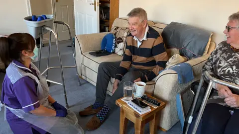 Martin Giles/BBC Richard Davenport with carer Nicky Ward and Jane Davenport