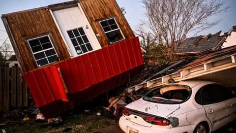 Getty Images An ambulance arrives at Rolling Fork, Mississippi, which was devastated by a tornado, 25 March