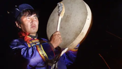 Grigory Sobchenko / Getty Images Shaman with drum