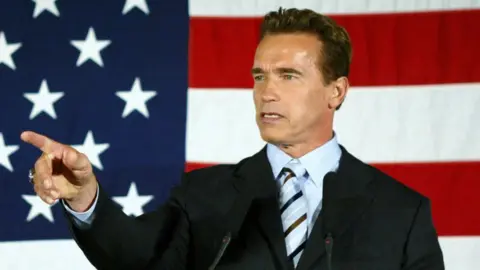 California Governor-elect Arnold Schwarzenegger holds a press conference following his appearance with U.S. President George W. Bush October 16, 2003 in San Bernardino, California.