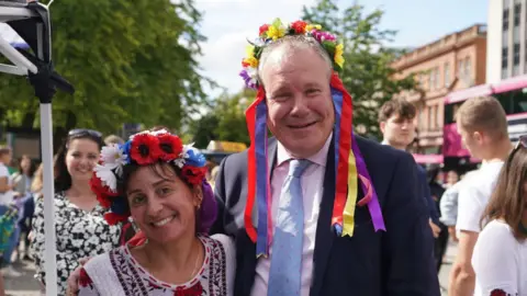 Niall Carson/PA Minister of State for Northern Ireland Conor Burns (right) met Marina Furey, who is originally from Ukraine, when he attended the event