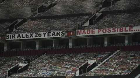 Reuters Banners hanging from a stand inside Old Trafford