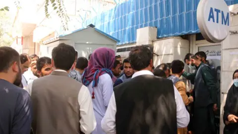 EPA Afghans outside a closed bank in Kabul on 25 August 2021