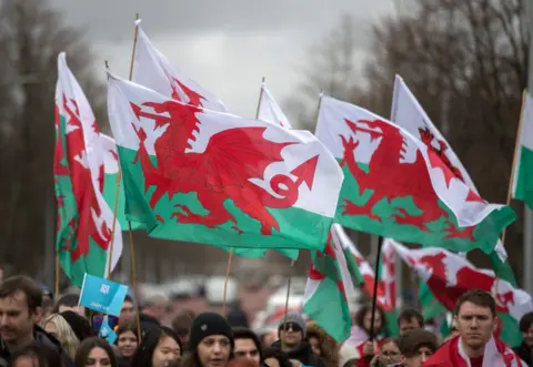 Getty Images People waving Welsh flags on St David's Day