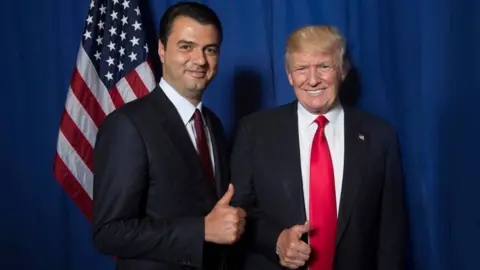 Democratic Party of Albania Lulzim Bashar and Donald Trump, both making a thumbs-up sign as they smile at the camera