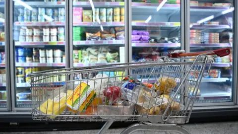 EPA/ANDY RAIN Shopping trolley holding items in a supermarket