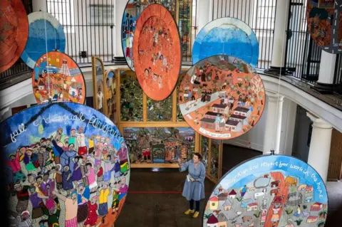 EPA Suspended, round, colourful artwork.