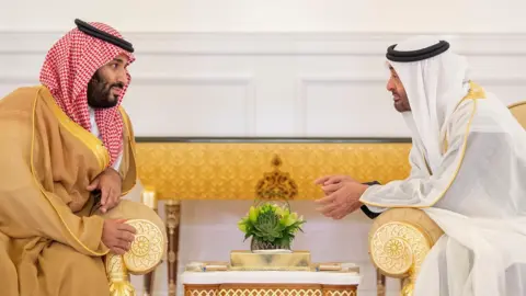 Anadolu Agency Saudi Crown Prince Mohammed bin Salman (L) speaks to Abu Dhabi Crown Prince Mohammed bin Zayed in Abu Dhabi on 22 November 2018