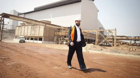 Bloomberg via Getty Images Dan Gertler walks through the Katanga Mining Ltd. copper and cobalt mine complex during a tour of the operations in Kolwezi, Democratic Republic of Congo, on Wednesday, Aug. 1, 2012.