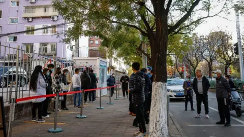 Shutterstock People queue for Covid testing in Beijing