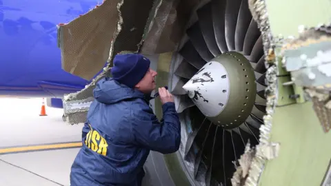 EPA Image from NTSB shows an investigator examining damaged engine of Southwest Airlines flight 1380. 17 April 2018