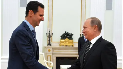 AFP/Getty Bashar al-Assad shakes hands with Vladimir Putin in Moscow