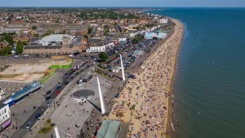 Getty Images Sunbathers on a beach in Southend-on-Sea