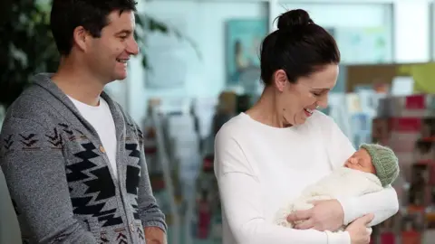 Getty Images New Zealand Prime Minister Jacinda Ardern and partner Clarke Gayford pose for a photo with their new baby girl Neve Te Aroha