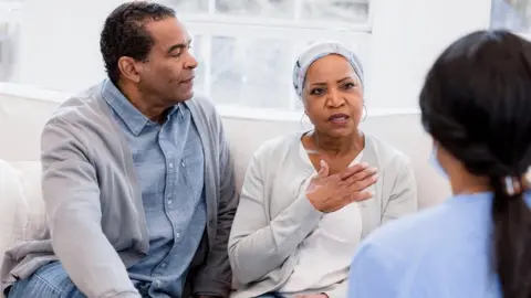 Getty Images Couple talking to a doctor