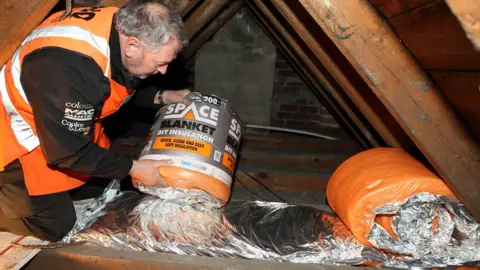 PA Man fitting loft insulation