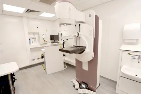 Helen Smith Photography A large piece of medical equipment that screens breasts