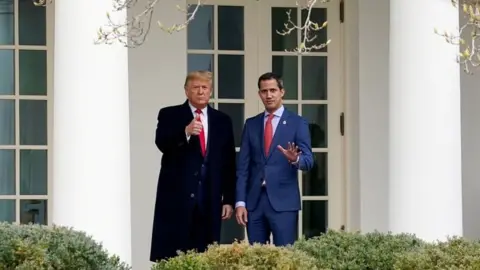 Reuters U.S. President Donald Trump gestures to gathered news media with Venezuela's opposition leader Juan Guaido at the White House in Washington on 5 February