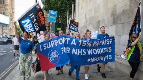 Getty Images Protestors calling for a 15% pay rise