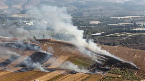 Reuters Smoke rises from shells fired from Israel in Maroun al-Ras village