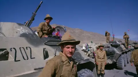 Getty Images View of Soviet army soldiers as they stand on an around armoured personnel carriers during the final Soviet troop withdrawal ceremony, Kabul, Afghanistan, May 15, 1988