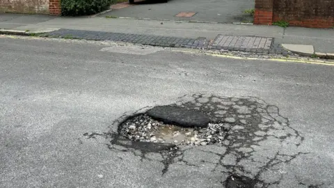 Steve Piercy A pothole, partially fixed, in Eastbourne
