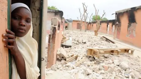 AFP A female student stands in a burnt classroom at a school in Maiduguri, Nigeria, on 12 May 2012
