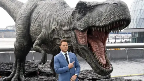 Getty Images Actor Chris Pratt and a model T-Rex