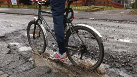 Getty Images Cyclist pothole