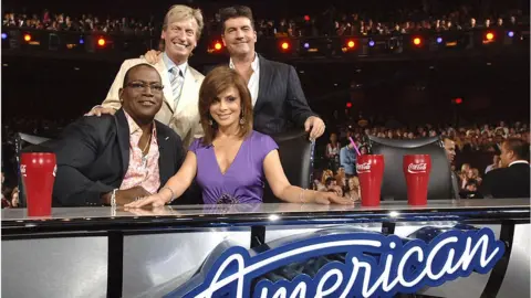 Getty Images Lythgoe, Cowell, Jackson and Abdul smile for a photo at the American Idol judges desk