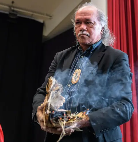 Getty Images Hendrick Fourmile of the Gimuy Walubara Yidinji people performs a ritual next to a coffin containing the remains of an Aboriginal ancestor