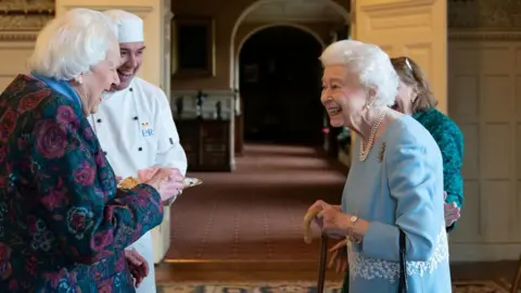 PA Media The Queen with Angela Wood, who helped make Coronation chicken for the first time