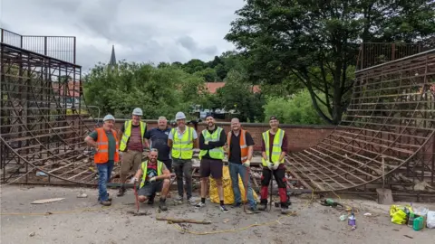 Ryan Swain Volunteers in front of the skate ramp they have helped clean up