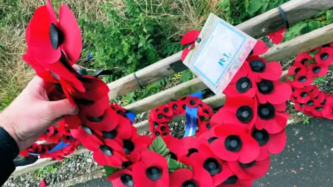 Richard McKee Damaged wreaths at the Narrow Water memorial