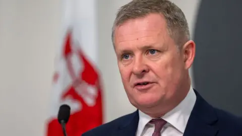 Getty Images Jeremy Miles at a Welsh government press conference