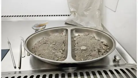 Tony Mayne/Environmental Services Dust in a metal tray in a testing facility